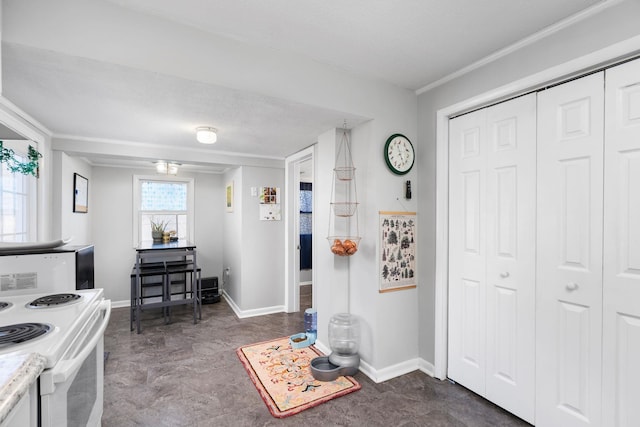 kitchen featuring white range with electric stovetop, light countertops, and baseboards