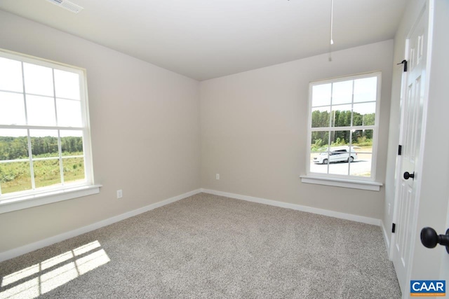 unfurnished room with a healthy amount of sunlight and light colored carpet