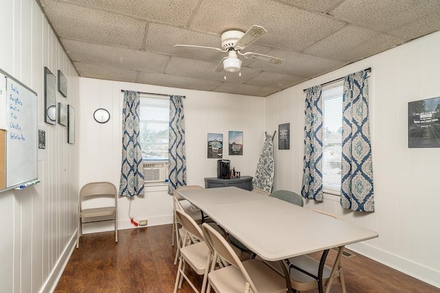 dining space featuring dark wood-type flooring, a paneled ceiling, ceiling fan, and cooling unit