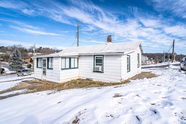 view of snowy exterior with cooling unit