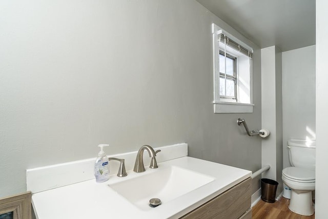 bathroom featuring hardwood / wood-style flooring, vanity, and toilet