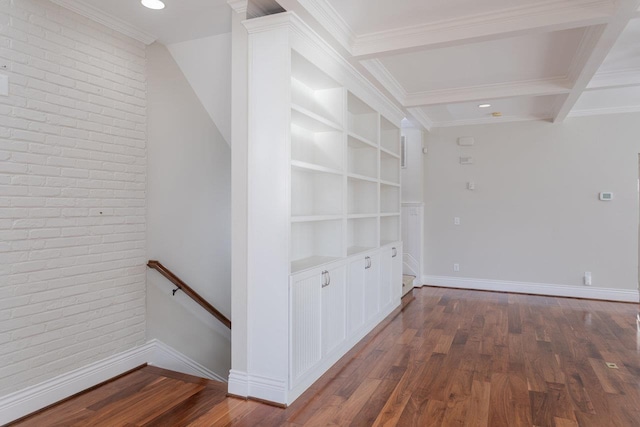 hall with coffered ceiling, built in shelves, dark wood-type flooring, and brick wall