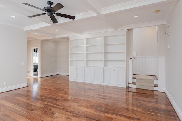 spare room with hardwood / wood-style flooring, coffered ceiling, and beam ceiling