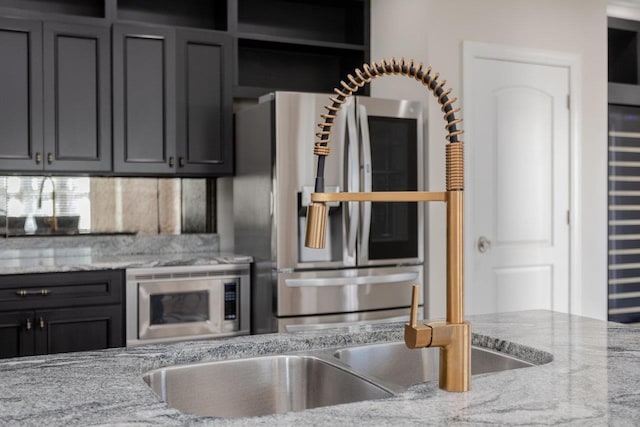 kitchen featuring light stone countertops and appliances with stainless steel finishes