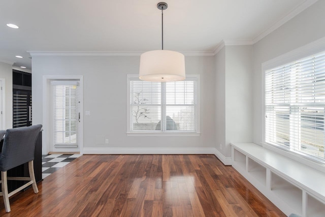 dining space with ornamental molding and dark hardwood / wood-style flooring