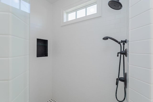 bathroom with tiled shower