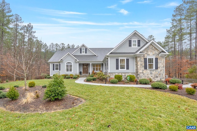 craftsman house featuring stone siding and a front lawn