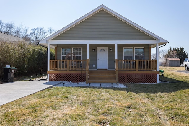 bungalow with a porch and a front yard