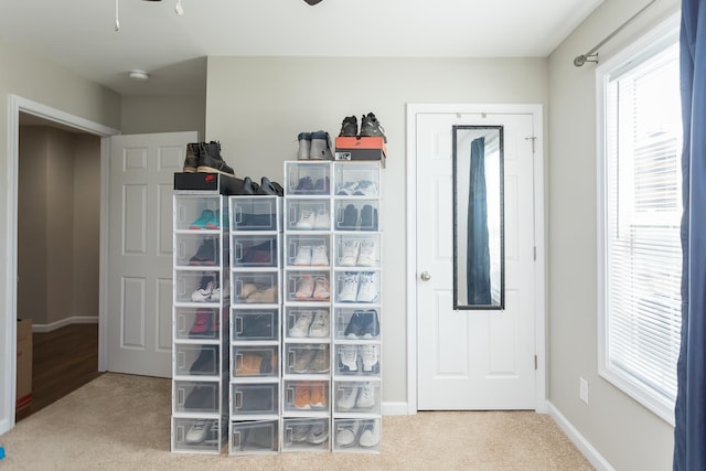 interior space with carpet floors and ceiling fan