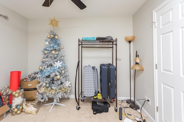 interior space with baseboards and a ceiling fan