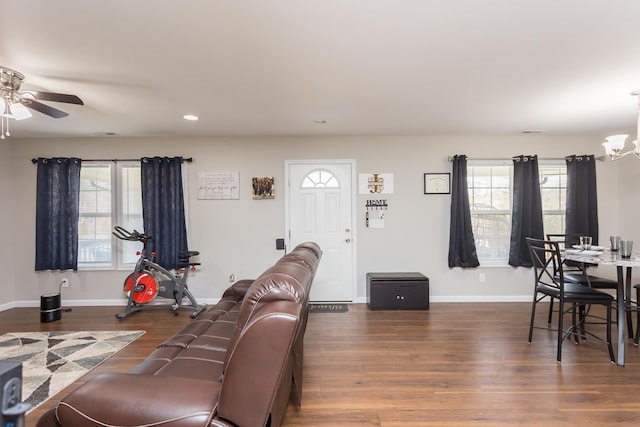 living room with baseboards, plenty of natural light, and wood finished floors