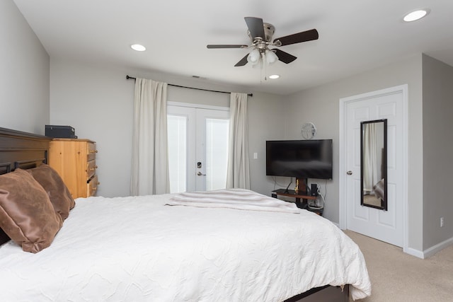 bedroom with recessed lighting, french doors, and light carpet