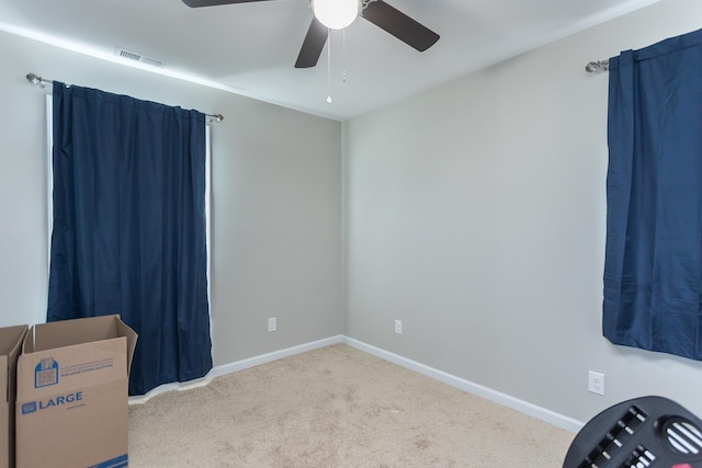 interior space featuring a ceiling fan, baseboards, and visible vents