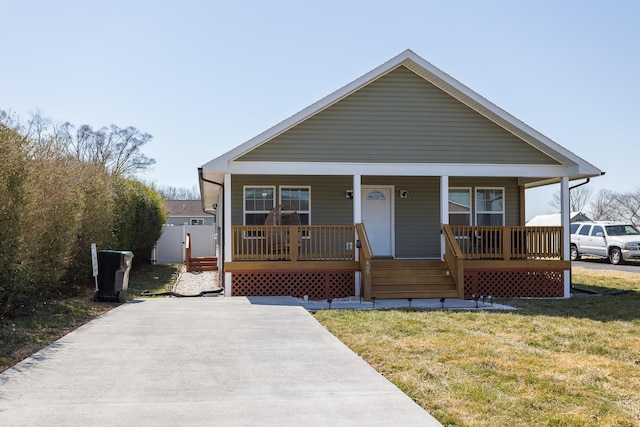 view of front of property with a front yard and covered porch