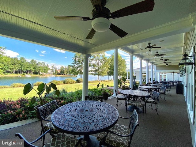 view of patio featuring a water view and ceiling fan