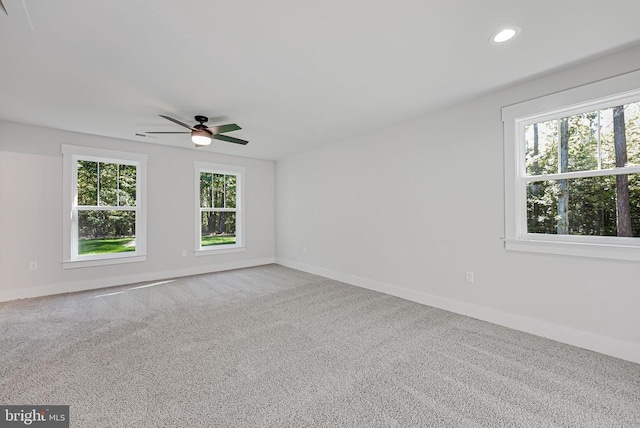 spare room featuring ceiling fan and carpet flooring