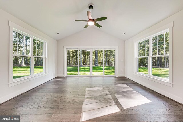 unfurnished sunroom featuring ceiling fan, plenty of natural light, and vaulted ceiling