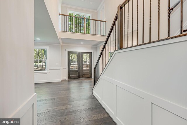 entrance foyer featuring french doors, crown molding, and a wealth of natural light