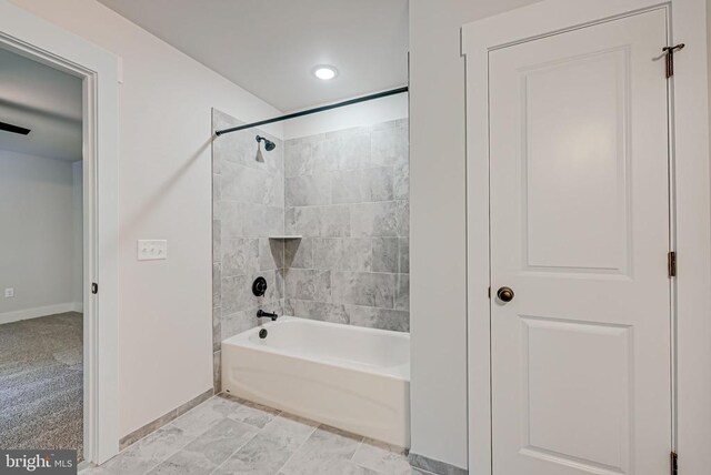 bathroom featuring shower / bathtub combination and baseboards