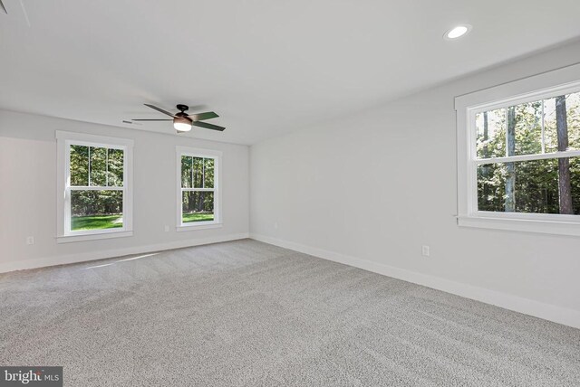 spare room with carpet floors and ceiling fan