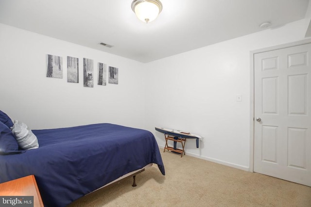 bedroom featuring visible vents, baseboards, and carpet