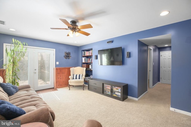 carpeted living area featuring french doors, baseboards, visible vents, and a ceiling fan