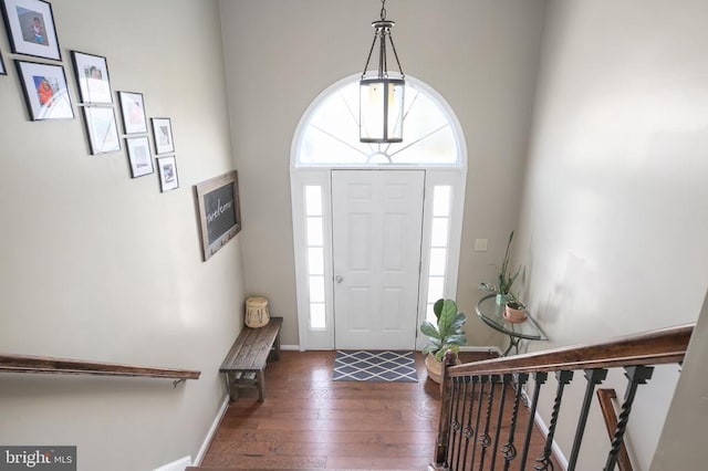 foyer with stairway, baseboards, and hardwood / wood-style flooring