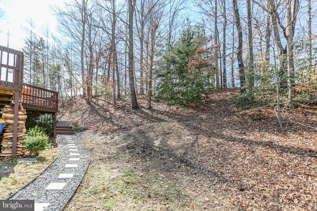 view of yard featuring a deck and stairs