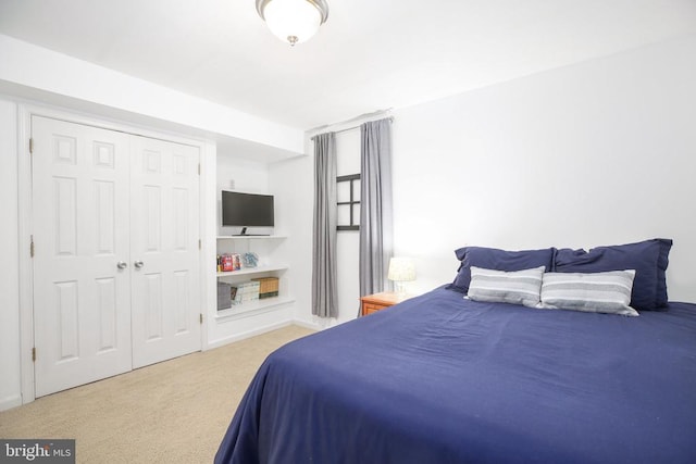 bedroom with a closet, carpet flooring, and baseboards