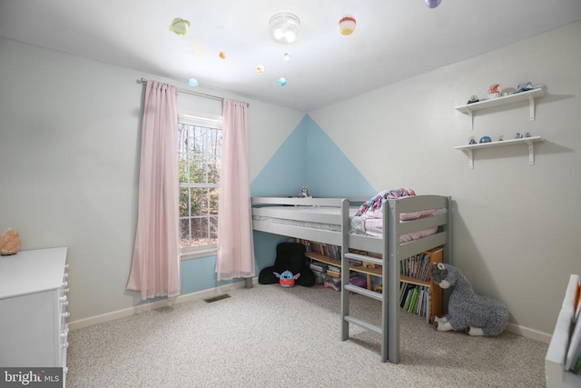 carpeted bedroom with visible vents and baseboards