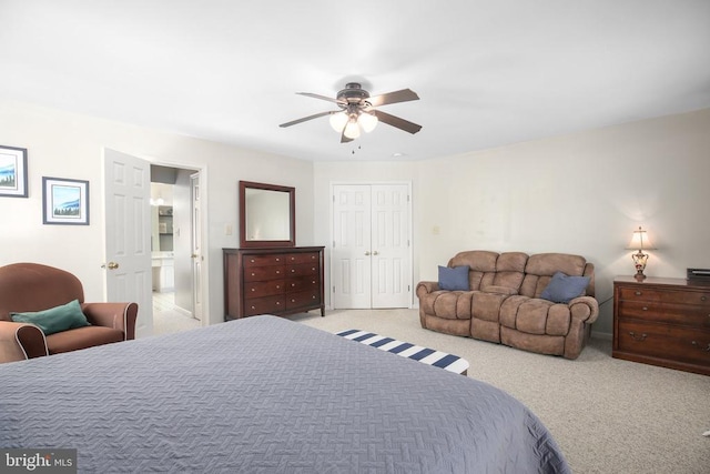 bedroom featuring ensuite bath, a ceiling fan, a closet, and carpet floors