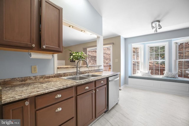 kitchen featuring a wealth of natural light, dishwasher, and a sink