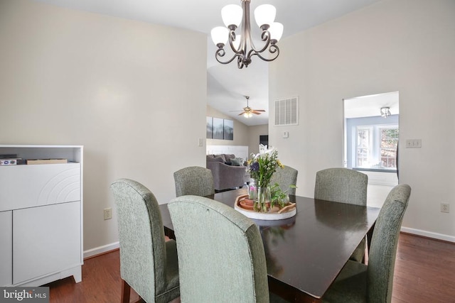 dining space featuring visible vents, a notable chandelier, wood finished floors, baseboards, and lofted ceiling