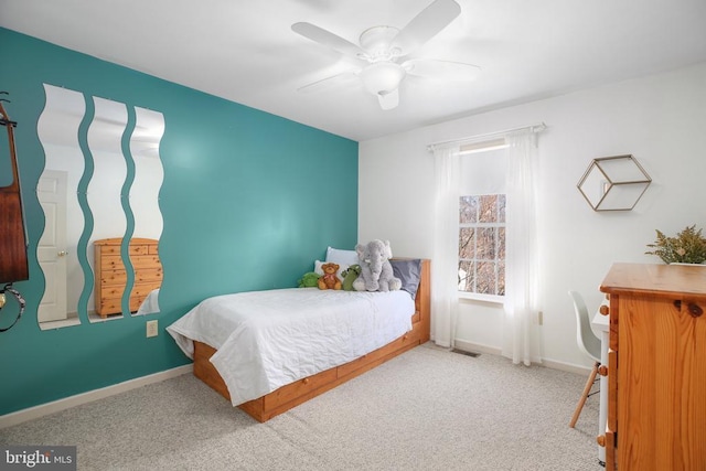 carpeted bedroom featuring ceiling fan and baseboards