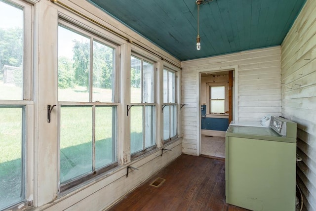 unfurnished sunroom with washing machine and dryer and wood ceiling