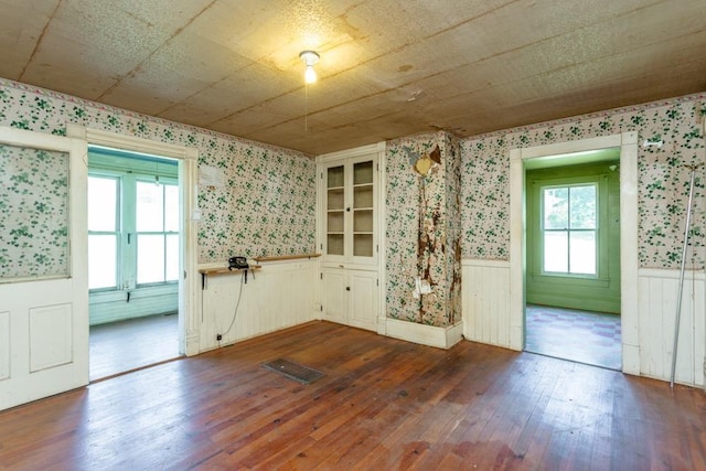 unfurnished dining area featuring dark wood-type flooring