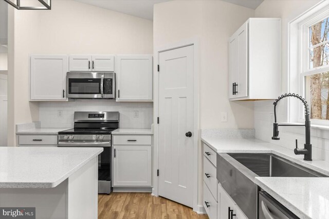 kitchen featuring white cabinetry, sink, and appliances with stainless steel finishes