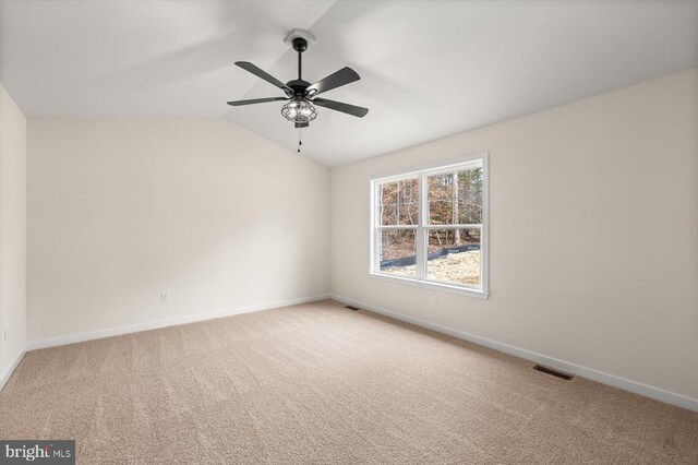 spare room with lofted ceiling, carpet flooring, and ceiling fan