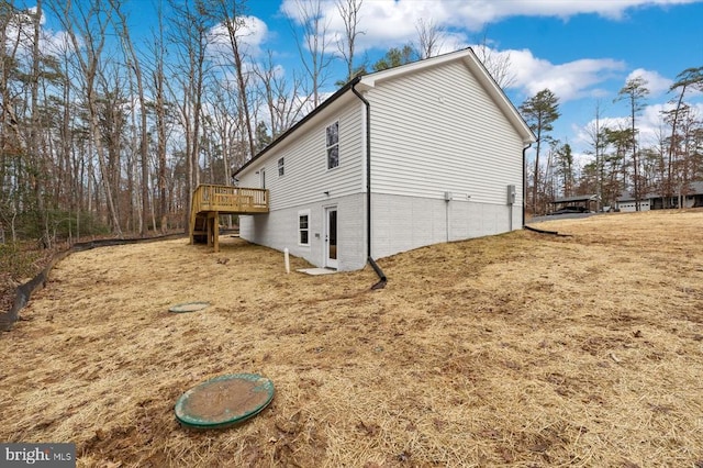 view of side of home with a deck