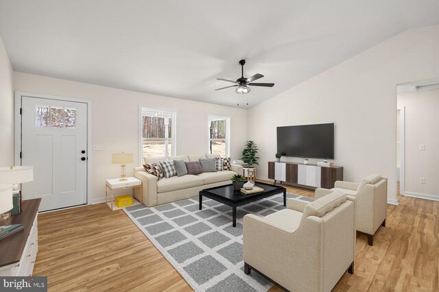 living room with lofted ceiling, light hardwood / wood-style flooring, and ceiling fan