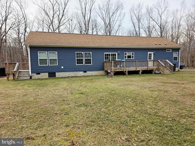 rear view of house featuring crawl space, a wooden deck, a yard, and a shingled roof