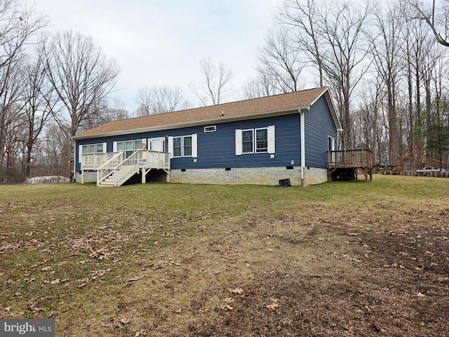 view of front of house with crawl space, a wooden deck, stairs, and a front lawn