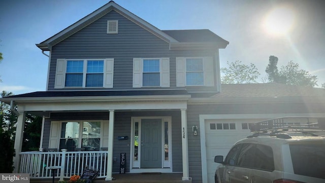 traditional home with a porch and an attached garage