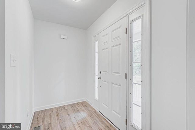 entrance foyer featuring baseboards, light wood-type flooring, and visible vents