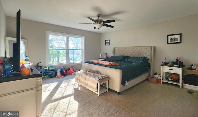 bedroom with carpet, a ceiling fan, and visible vents