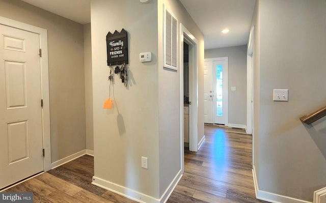 interior space featuring baseboards, recessed lighting, and wood finished floors
