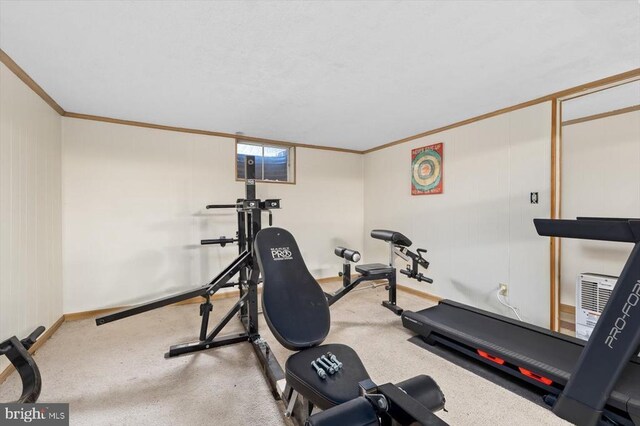 workout area featuring crown molding