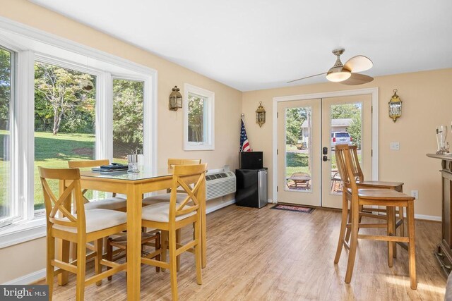 dining room featuring french doors, ceiling fan, and light hardwood / wood-style flooring