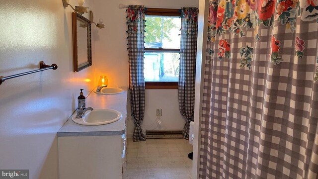 bathroom with tile patterned floors, vanity, a shower with shower curtain, and a baseboard heating unit