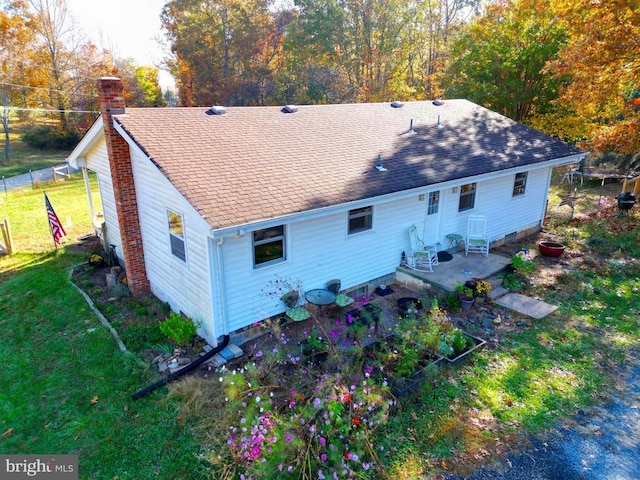 rear view of house featuring a yard and a patio area